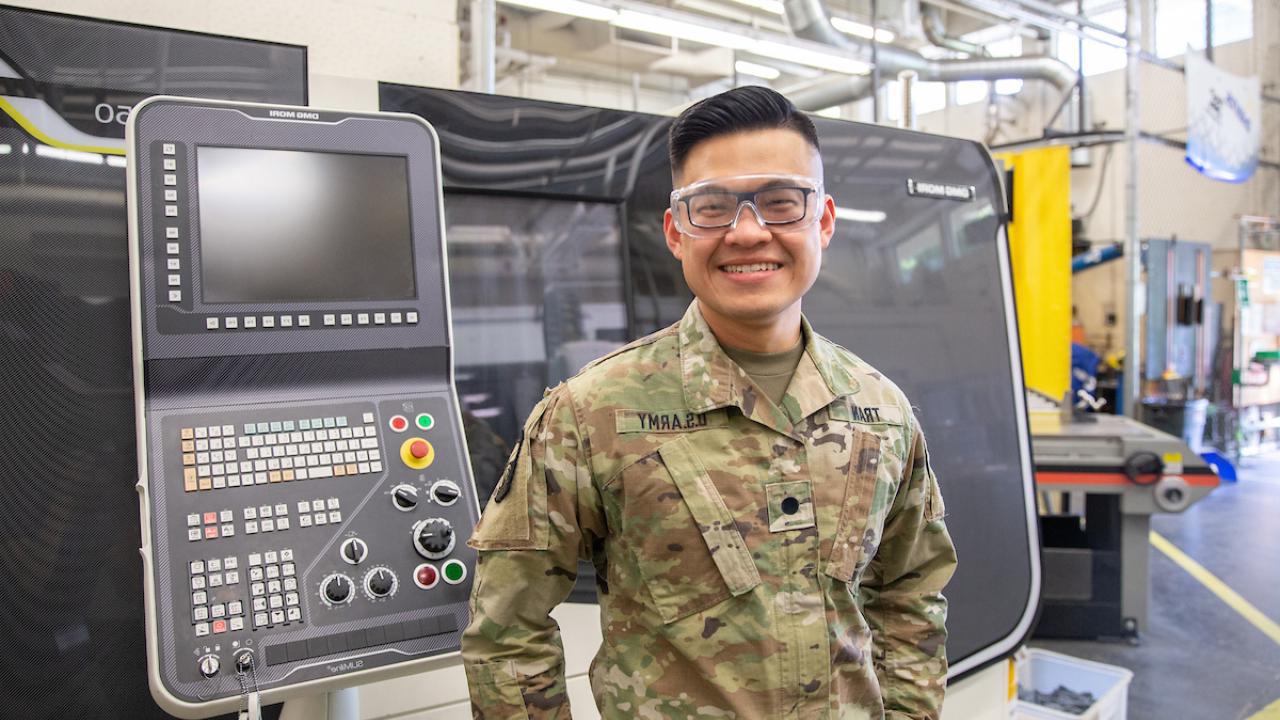 student dressed in military fatigues in a lab